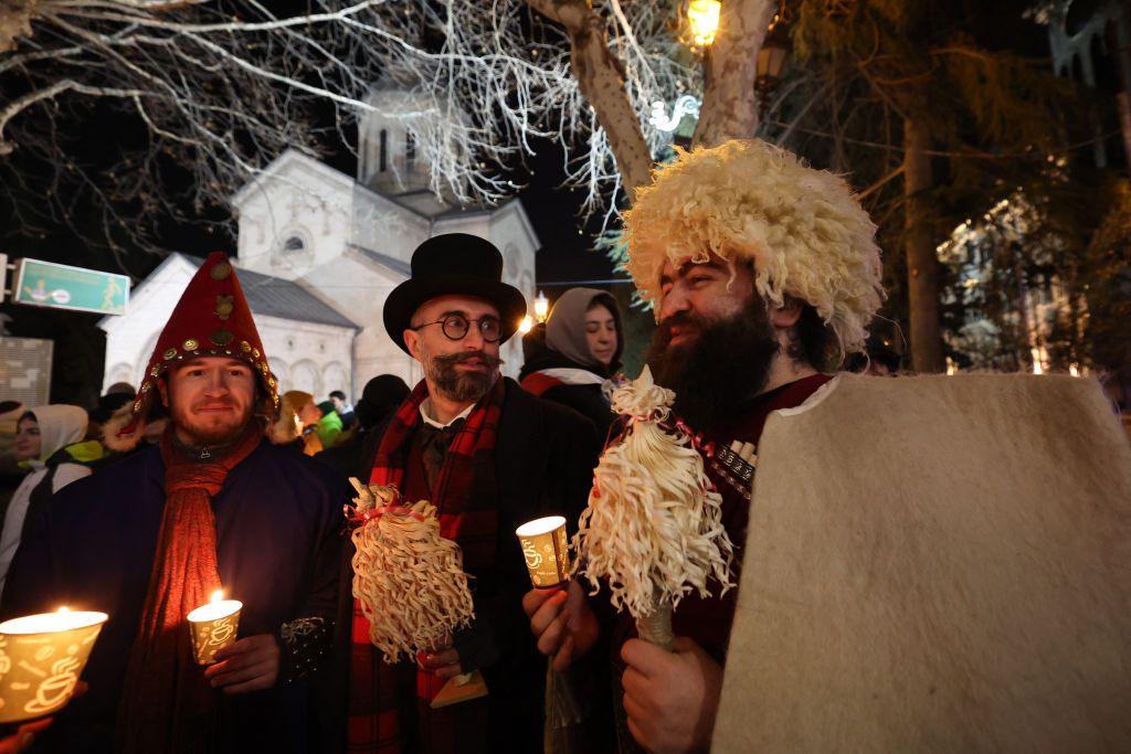 People holding candles gather to celebrate Orthodox Christmas eve along Rustaveli Avenue, in central Tbilisi on January 6, 2025.