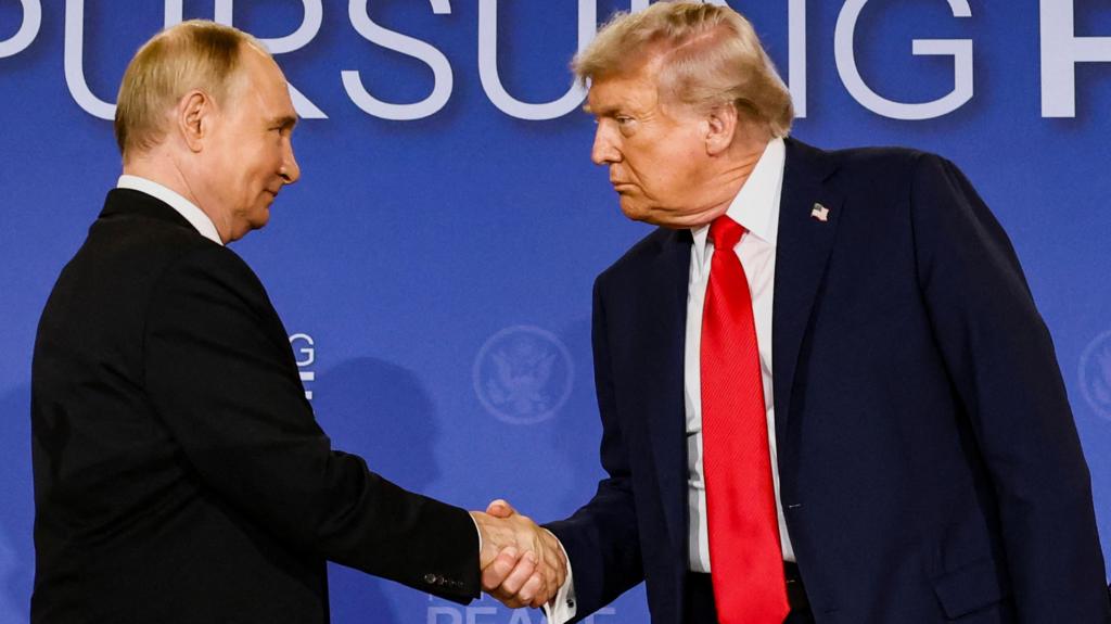 US President Donald Trump and Russian President Vladimir Putin shake hands during a press conference