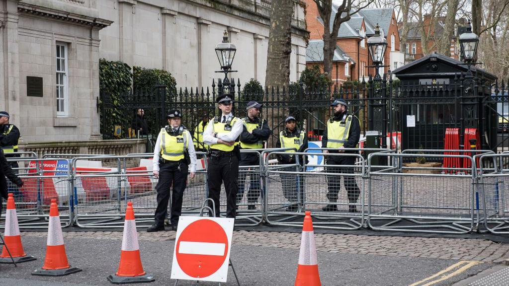Police block the entrance to the Israeli embassy in March 2025