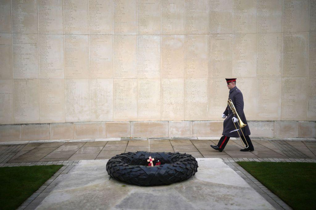 A musician from the Band of the British Army walks past the names of the fallen after the Armistice Day commemoration at the National Memorial Arboretum 