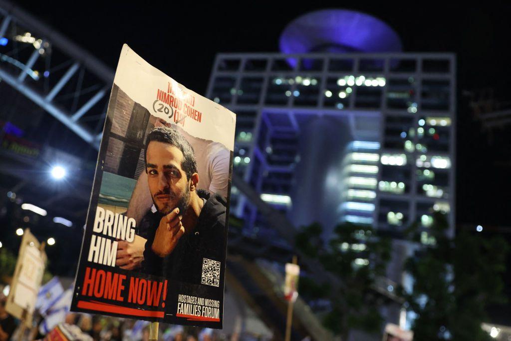 A protester carries a portrait of Nimrod Cohen in October 2024.