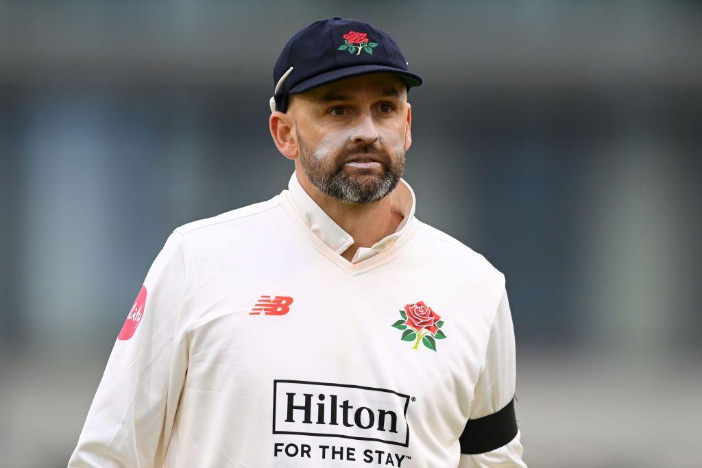 Nathan Lyon looking glum in a Lancashire shirt