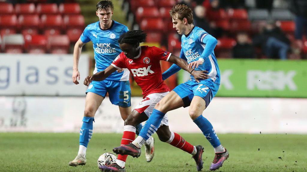 Peterborough United's Hector Kyprianou and Charlton Athletic's Tyreece Campbell compete for the ball, with the Posh's Oscar Wallin just behind. 
