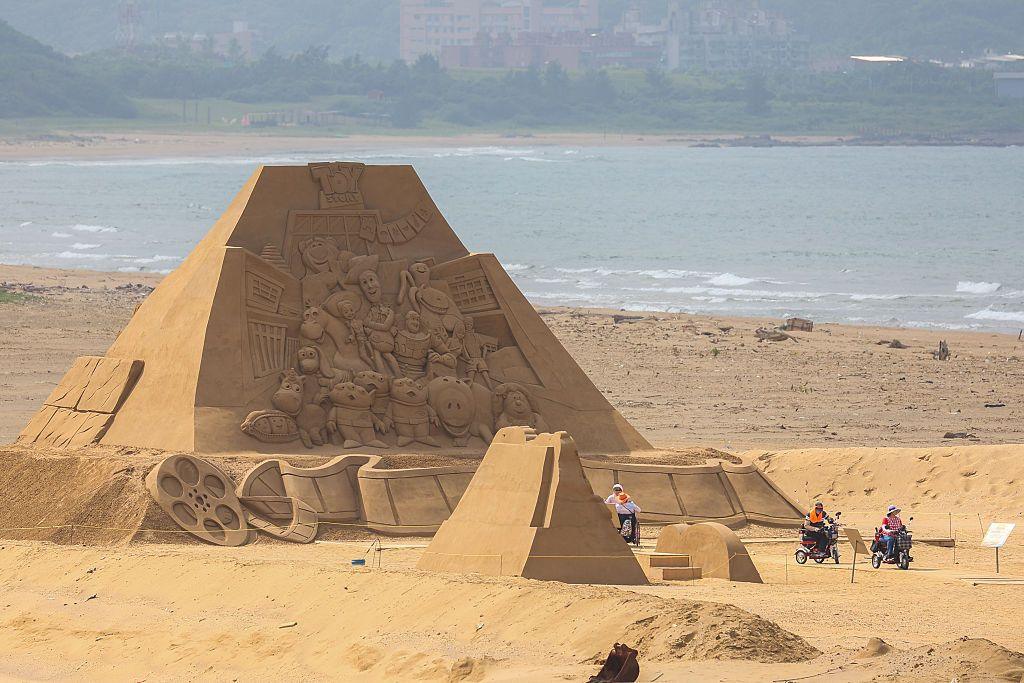 Distant view of a sand art pyramid of Toy Story characters