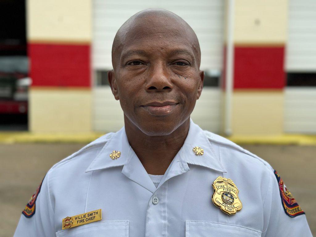 Tuskegee Fire Department Chief Willie Smith poses in front of the fire department for a portrait 