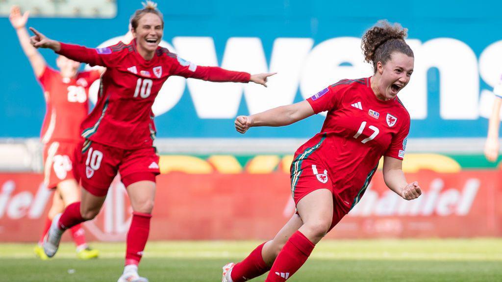 Jess Fishlock celebrates with Mary McAteer during a match.