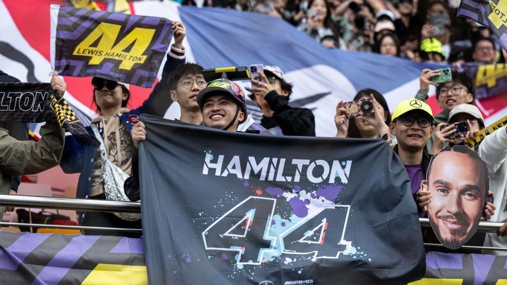 Fans in China hold up signs for Lewis Hamilton