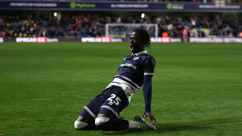 Romain Esse celebrates scoring a goal 