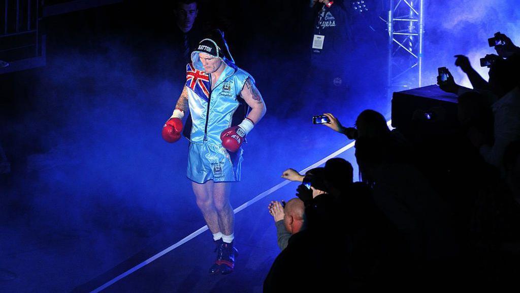 Ricky Hatton makes his ring walk dressed in Manchester City inspired top and shorts