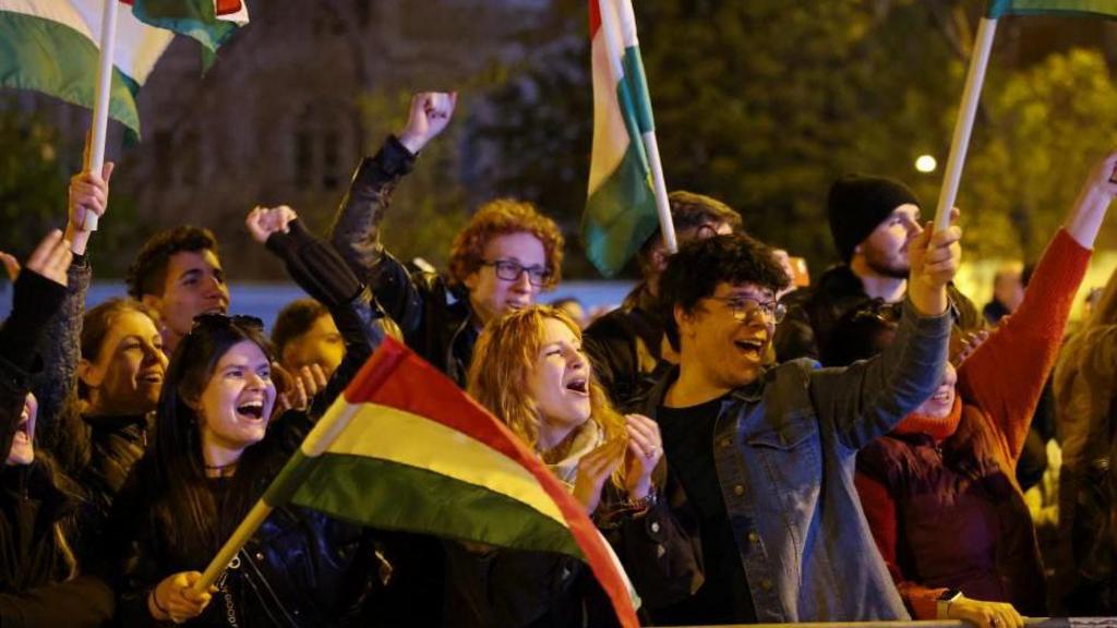 Crowds celebrating and waving flags in Budapest
