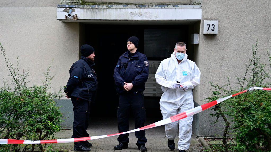 A criminal investigation unit technician leaves a building believed to be the site where a German activist of the notorious far-left Red Army Faction (RAF) wanted for more than 30 years for attempted murder and other crimes has been arrested in Berlin, on February 27, 2024