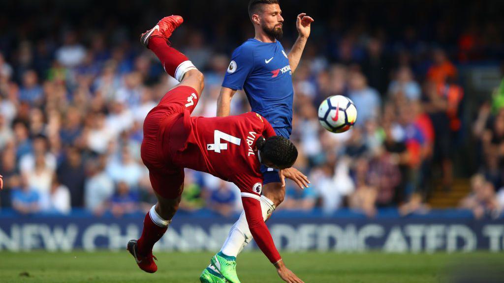 Olivier Giroud and Virgil van Dijk (left) challenge for the ball during a game between Liverpool and Chelsea in 2018. Giroud scored the winner in Chelsea's 1-0 win at Stamford Bridge