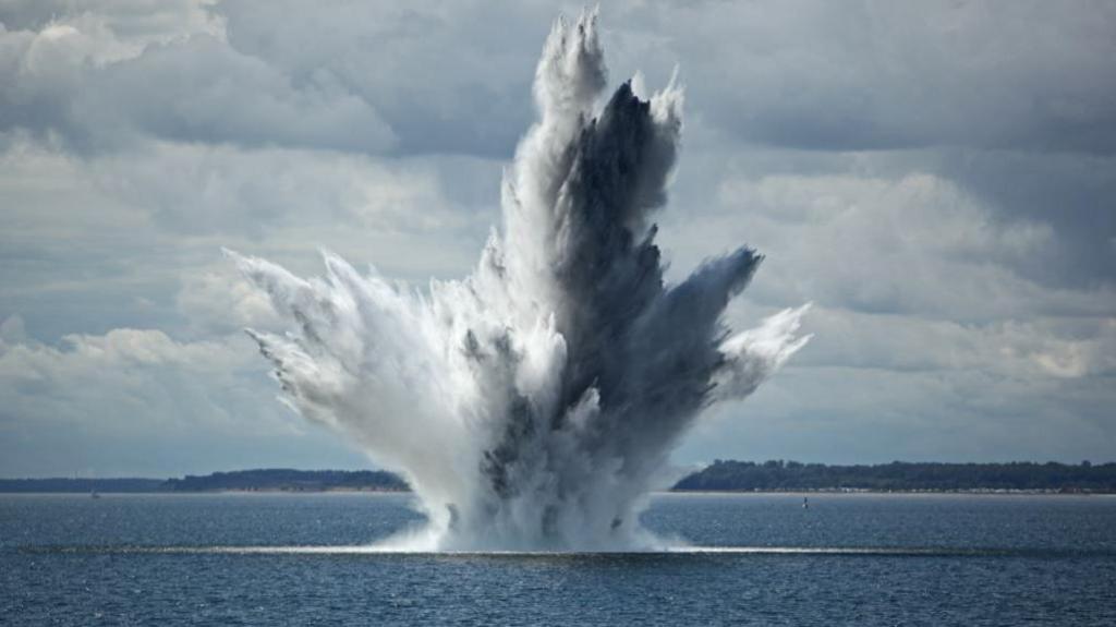 Huge water fountain caused by the underwater explosion of a sea mine in the ocean