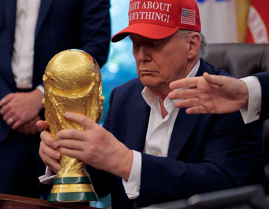 Donald Trump holding the World Cup trophy