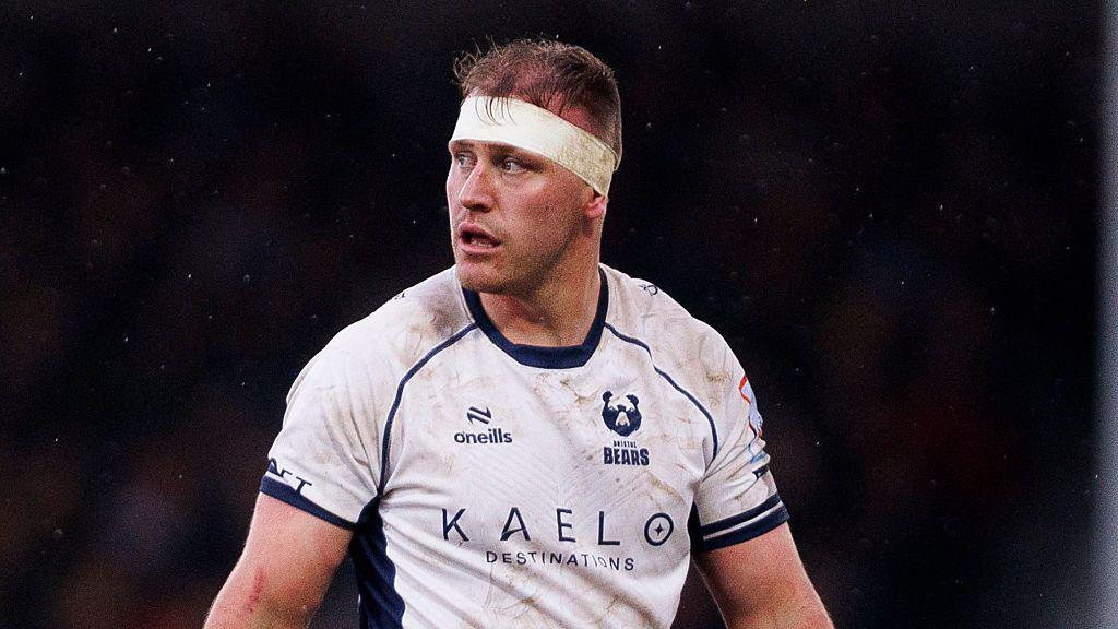 Joe Batley standing on the pitch looking over his shoulder during a match for Bristol 