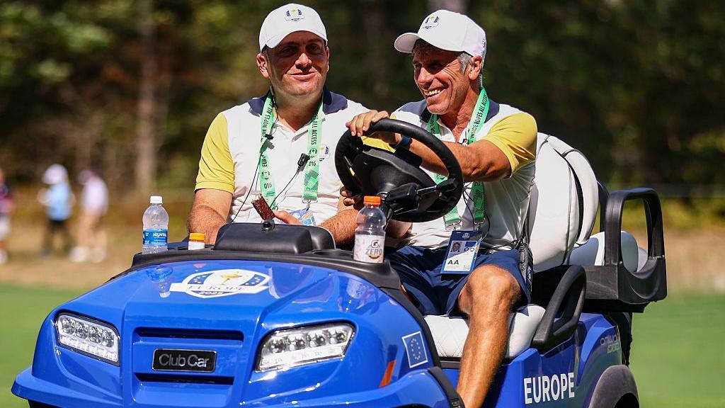 Francesco Molinari (left) being driven in a buggy by Gianfranco Zola