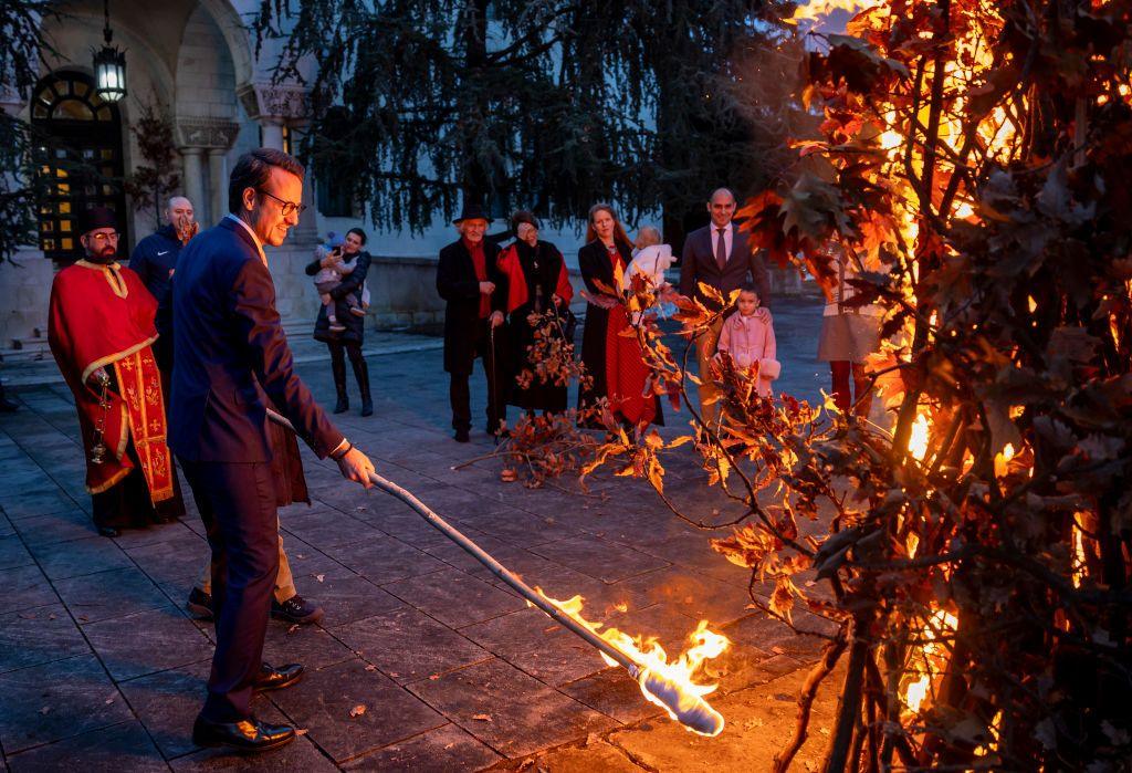 Prince Philip (L) of Serbia attends the ceremonial burning of dried oak branches, the Yule log symbol for the Orthodox Christmas Eve, in front of the Beli Dvor on January 06, 2025 in Belgrade, Serbia.