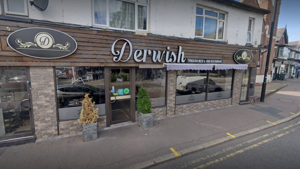 A restaurant frontage with the word "Derwish" displayed in large silver letters