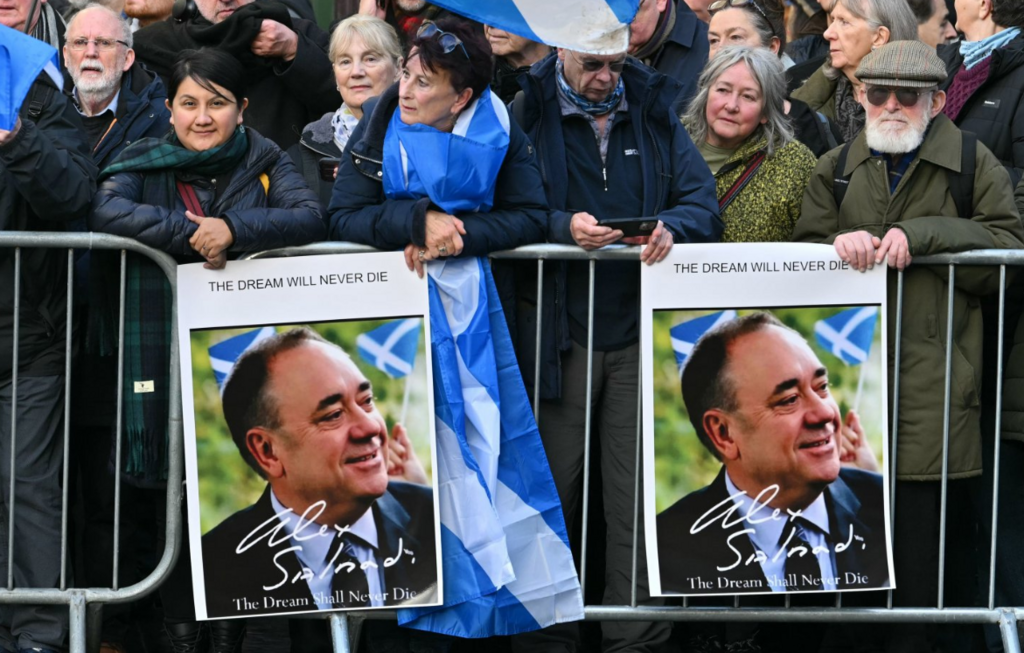 Crowd of well-wishers, holding placards, outside St Giles' Cathedral where Alex Salmond's memorial service took place