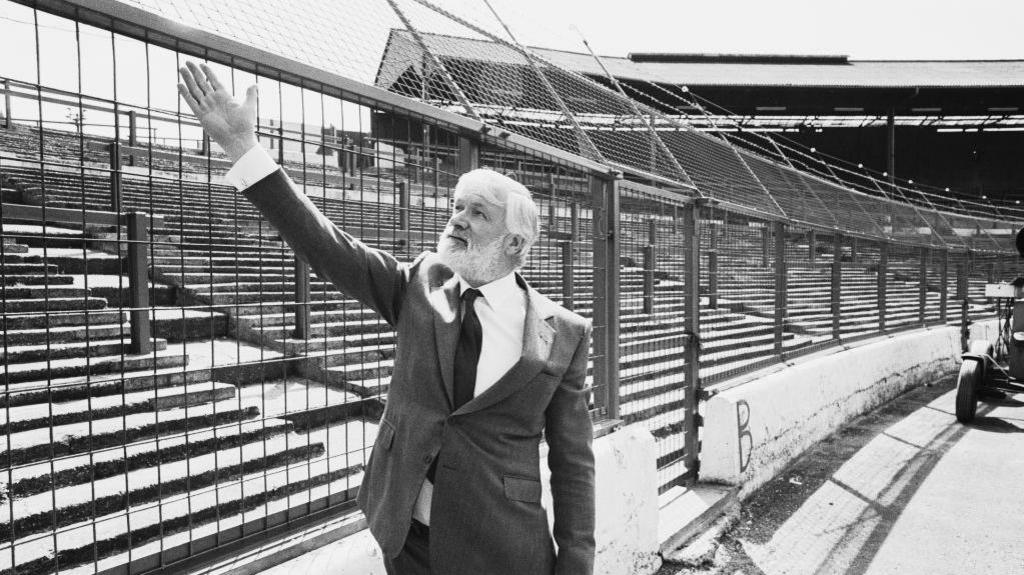 British businessman Ken Bates, owner of Chelsea Football Club, shows off the new electric perimeter fence at Stamford Bridge in 1985
