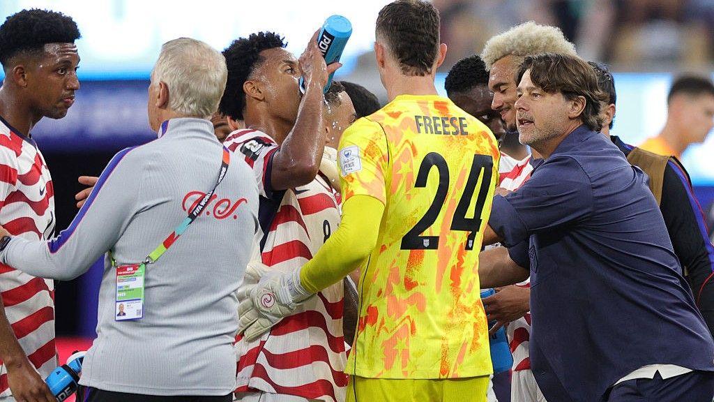USA players drinking water during a hydration break against Paraguay