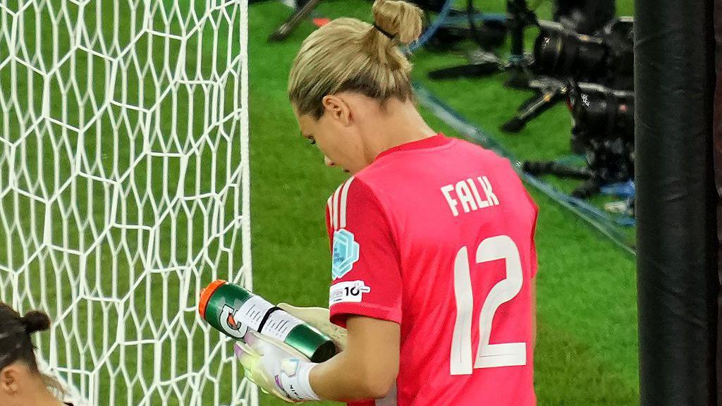 Sweden keeper Jennifer Falk reads notes on her water bottle about England's penalty takers in the Euro 2025 quarter-final