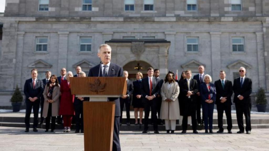 Mark Carney gives a speech with his new cabinet sitting behind him