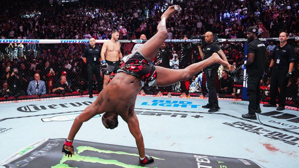 Jon Jones does a cartwheel in the octagon 