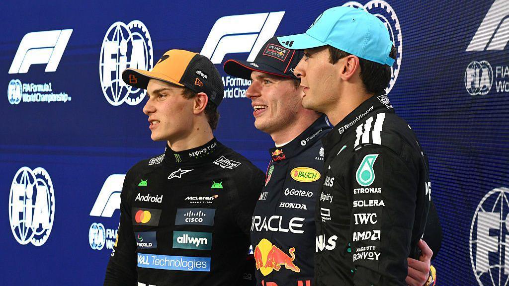 Oscar Piastri, Max Verstappen and George Russell pose for pictures after qualifying