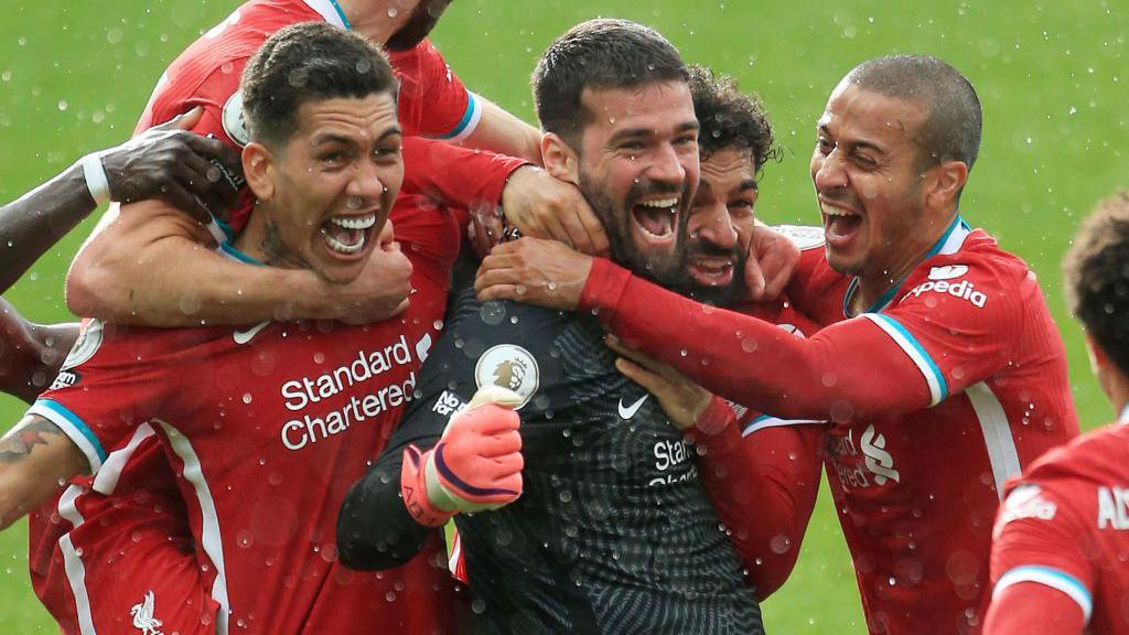 Alisson celebrates with team-mates after scoring for Liverpool against West Brom