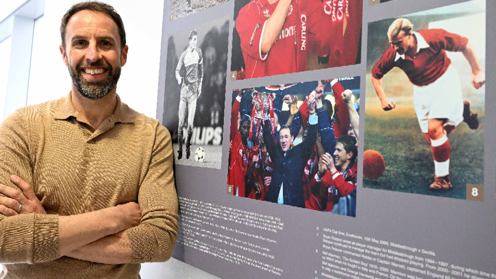 Gareth Southgate leaning against Sir Bobby sign