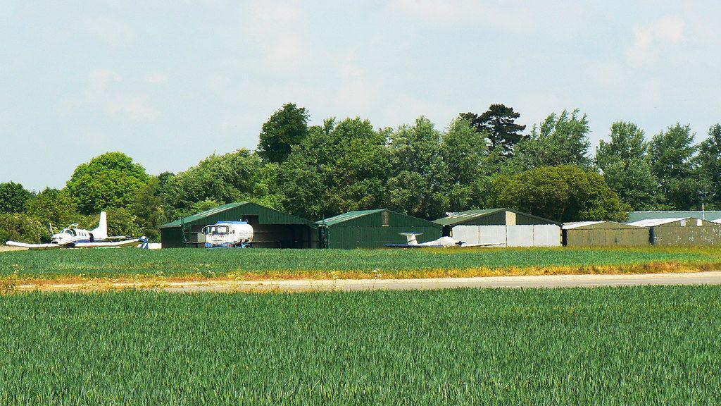 Hinton-in-the-Hedges airfield near Brackley in Northamptonshire. The airfield has planes and sheds.
