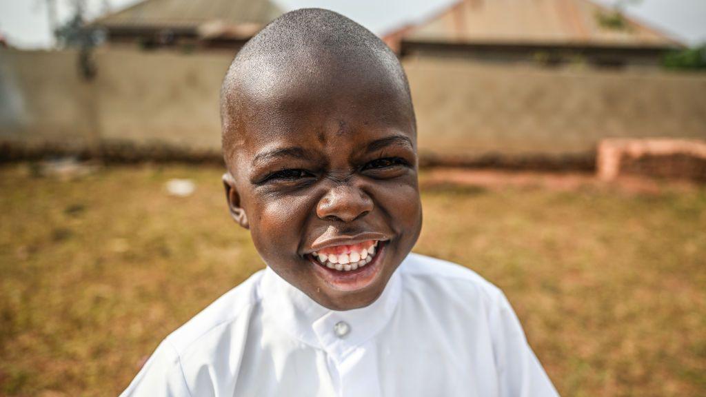 Photo shows a Ugandan child poses cheerily for a portrait after receiving baloons and candy during Eid al-Adha, the Feast of Sacrifice, on June 16, 2024 in Kappala, Uganda. Children of families struggling to survive with limited means in the rural areas of Kampala, the capital of Uganda, were happy with the balloons and candies distributed by the 'Just Human International Relief Organization'. The officials of the association, which is carrying out aid activities in the region for Eid al-Adha, distributed candy and balloons to approximately 25 thousand children, including orphans, in Busabala town of Kampala city. 