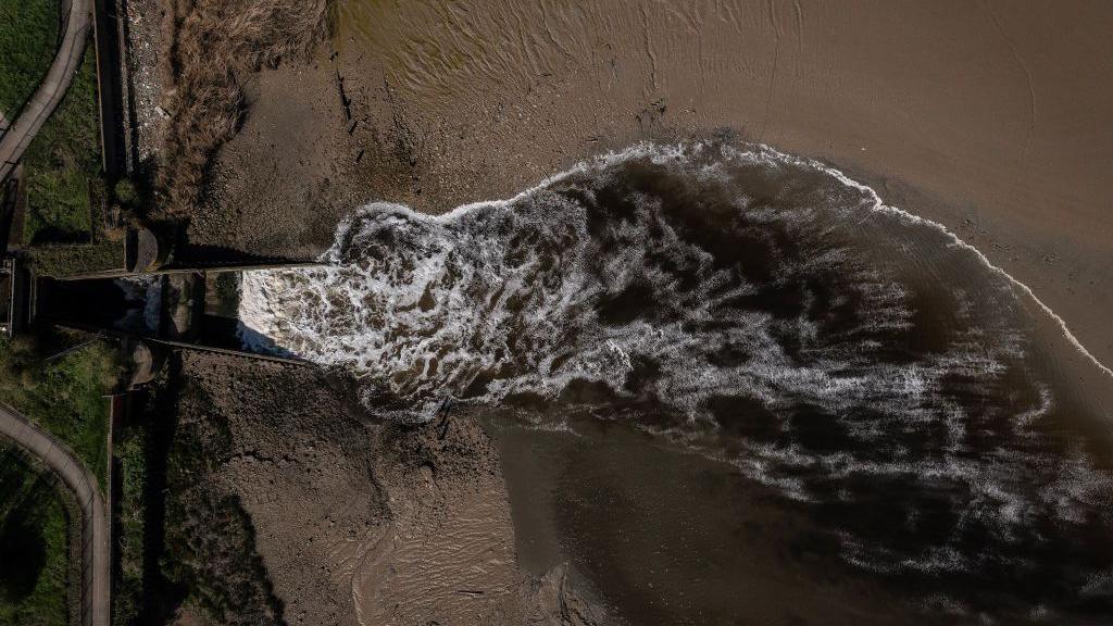 An aerial view of sewage discharge flowing into the River Thames at Crossness sewage treatment works in 2024