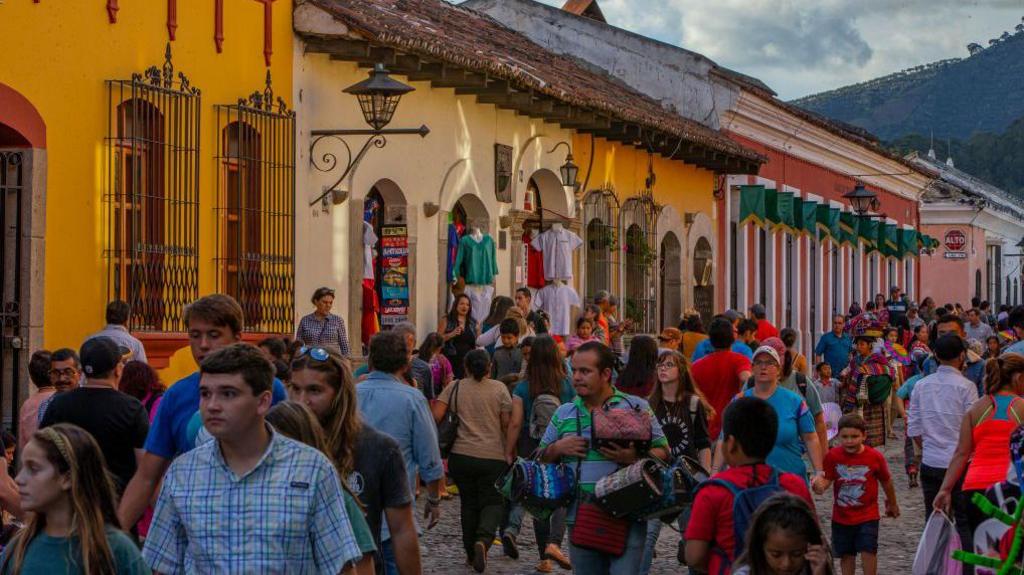 Tourists crowd the streets of Antigua