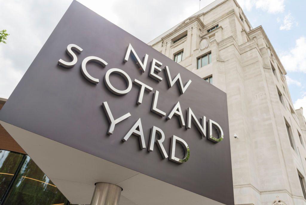 Sign of New Scotland Yard, a large pale stone building
