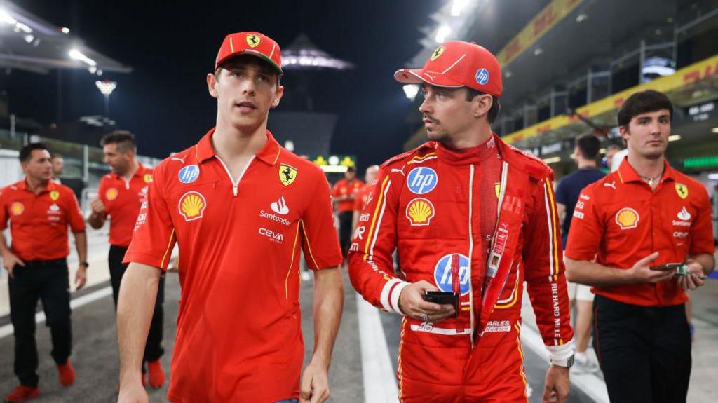 Arthur and Charles Leclerc talking to each other at the Abu Dhabi Grand Prix