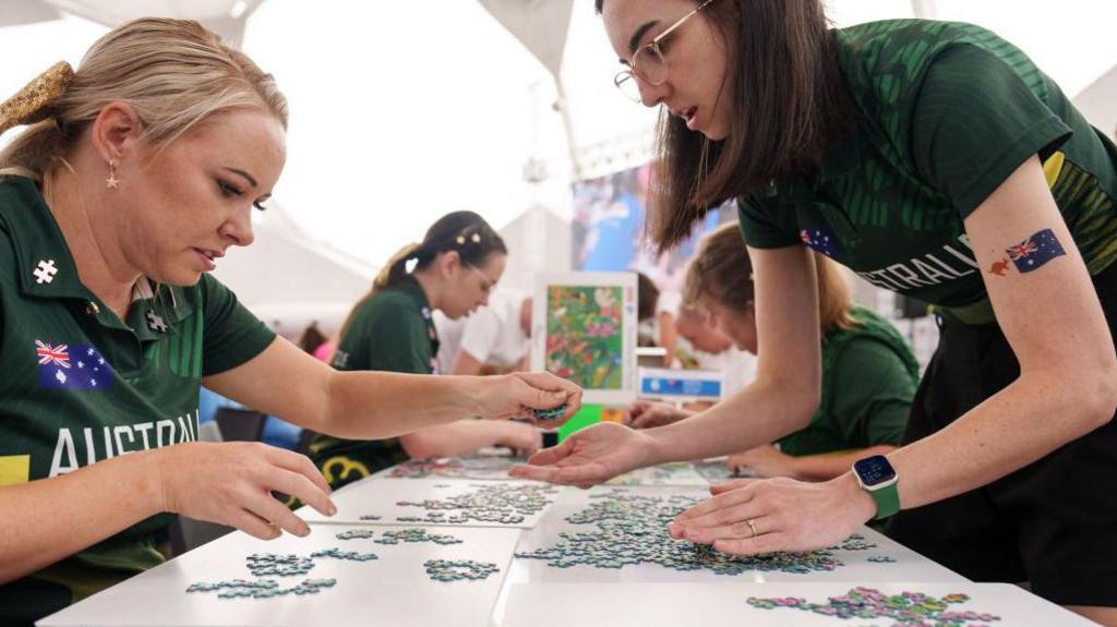 Two people looking at jigsaw pieces