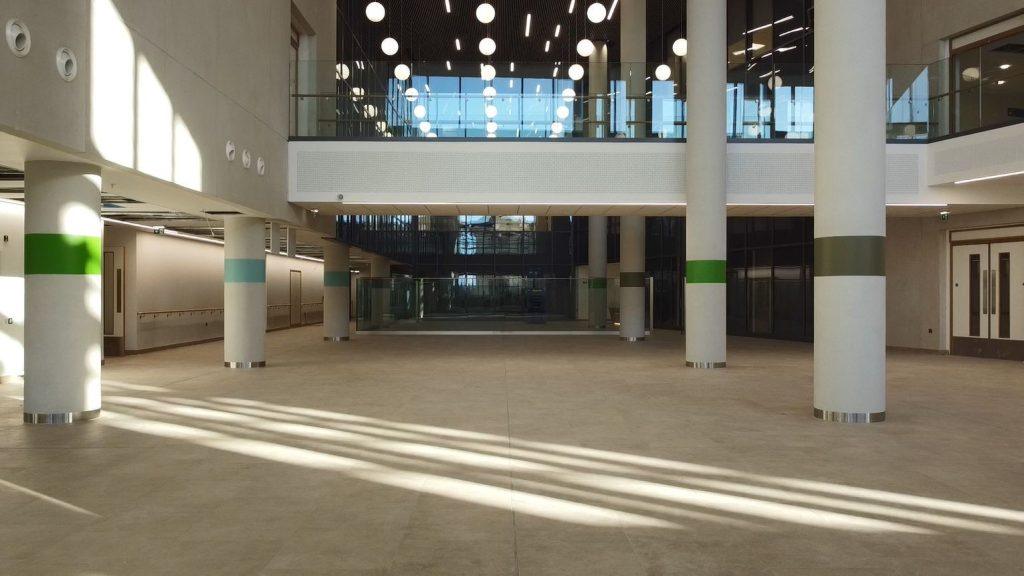 The atrium of the new building with columns, light and glass