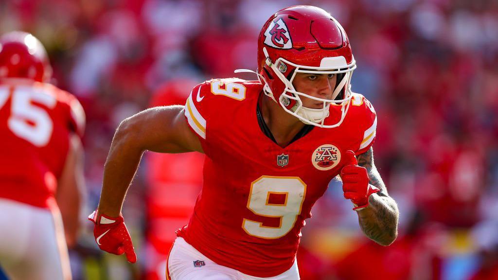 Louis Rees-Zammit runs in the red jersey and helmet of Kansas City Chiefs
