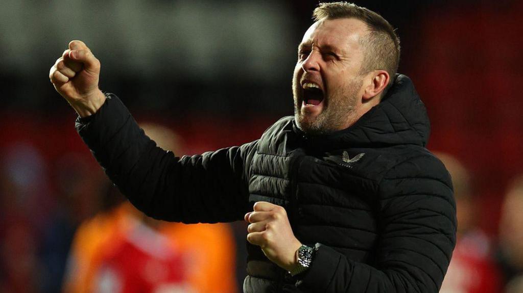 Nathan Jones punches the air in celebration