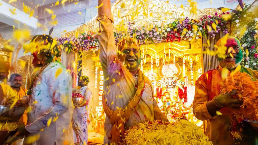 Man throwing flower petals 