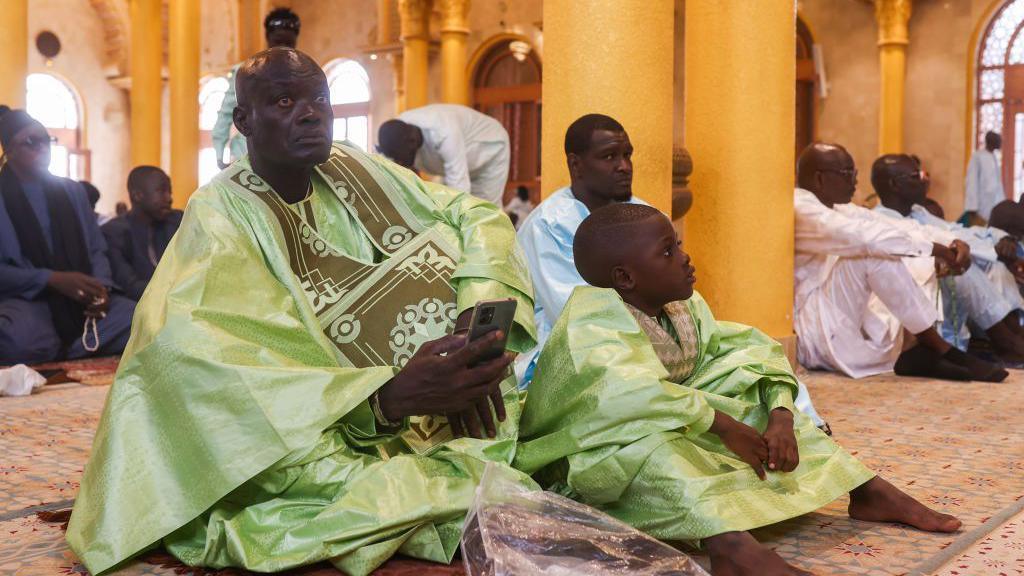 People arrive at mosques in Dakar, Senegal for Eid prayer