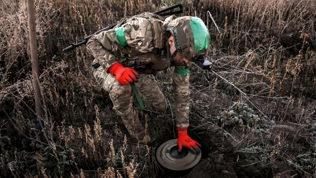 Servicemen of the 24th Mechanized Brigade install anti-tank landmines and non-explosive obstacles along the frontline at an undisclosed location near Chasiv Yar, Donetsk region, eastern Ukraine, on 30 October 2024