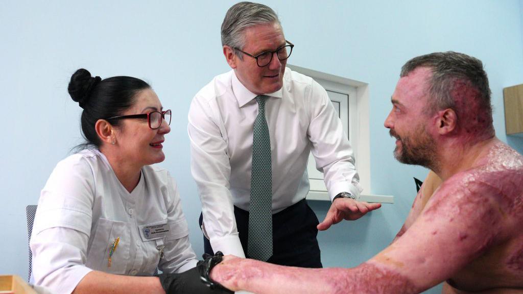 The prime minister meeting an injured patient at the hospital's burn's unit