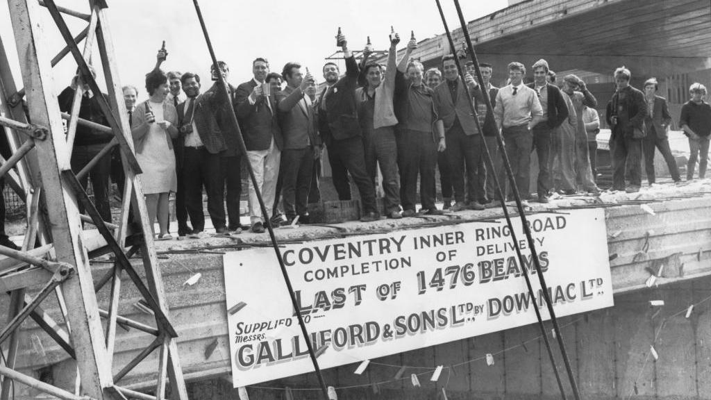 Fifty men with a bottle of beer each to celebrate the lowering into position of the last concrete beam on stage five of Coventry's Inner Ring Road