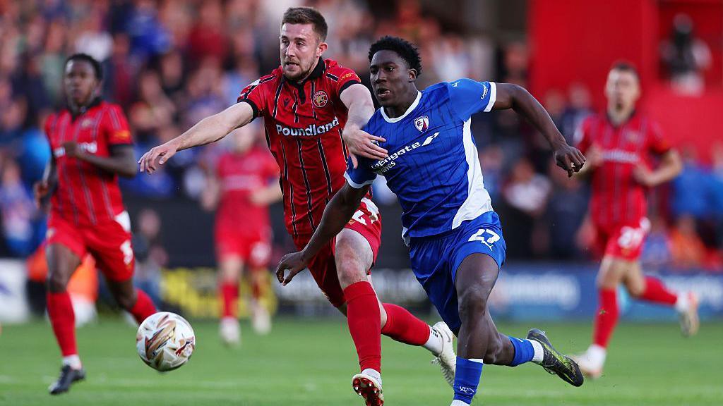 Harry Williams of Walsall is challenged by Aribim Pepple of Chesterfield
