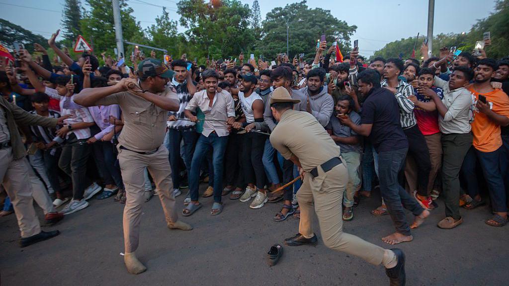 Police officers try to control fans of the Royal Challengers Bengaluru (RCB) and get them to disperse from outside the M. Chinnaswamy Stadium on June 04, 2025 in Bengaluru, India.