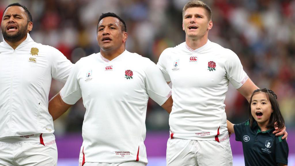 From left, Billy and Mako Vunipola and Owen Farrell with a mascot, representing England at the 2019 World Cup in Japan 