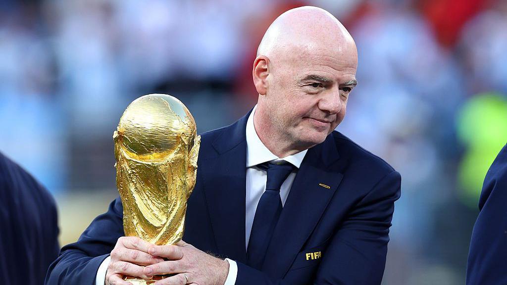 Gianni Infantino with the World Cup trophy.